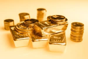 Gold bars and stack of gold coins macro. Rows of coins and gold ingots for finance and banking concept. Economy trends background for business idea. Trade in precious metals. Close up,Selective focus.