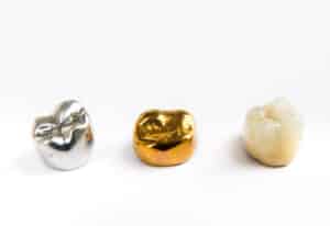 Dental ceramic, gold and metal tooth crowns on white background. Isolated.